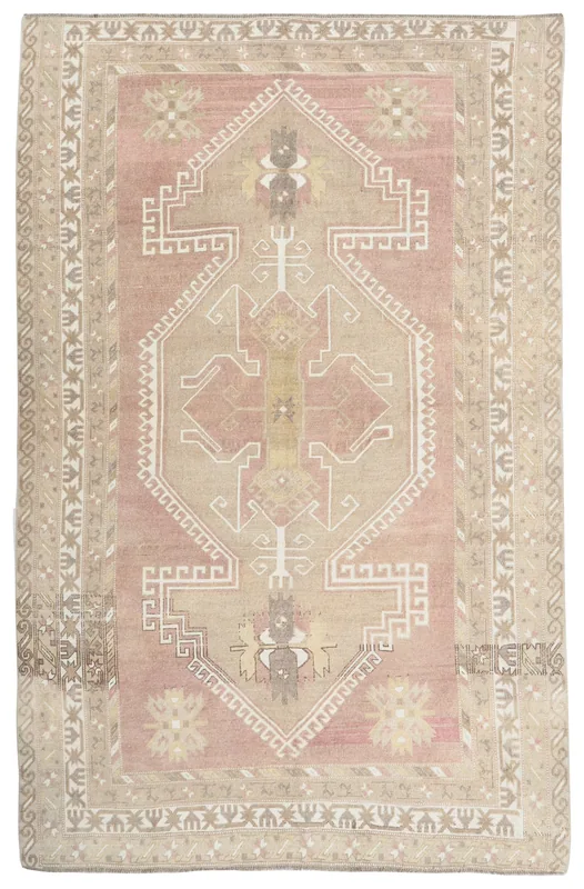 Full overhead view of the rose toned geometric medallion rug on a white background