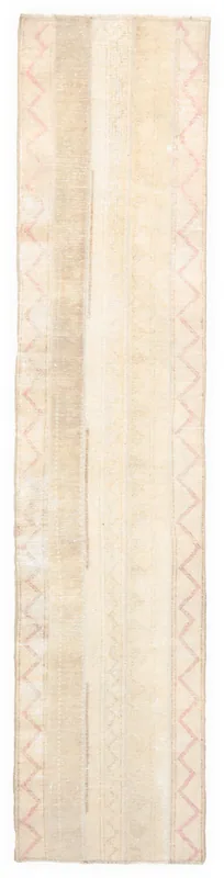 Full overhead view of the vintage 2'5" x 11'3" Anatolian runner rug with ivory and rose geometric patterns