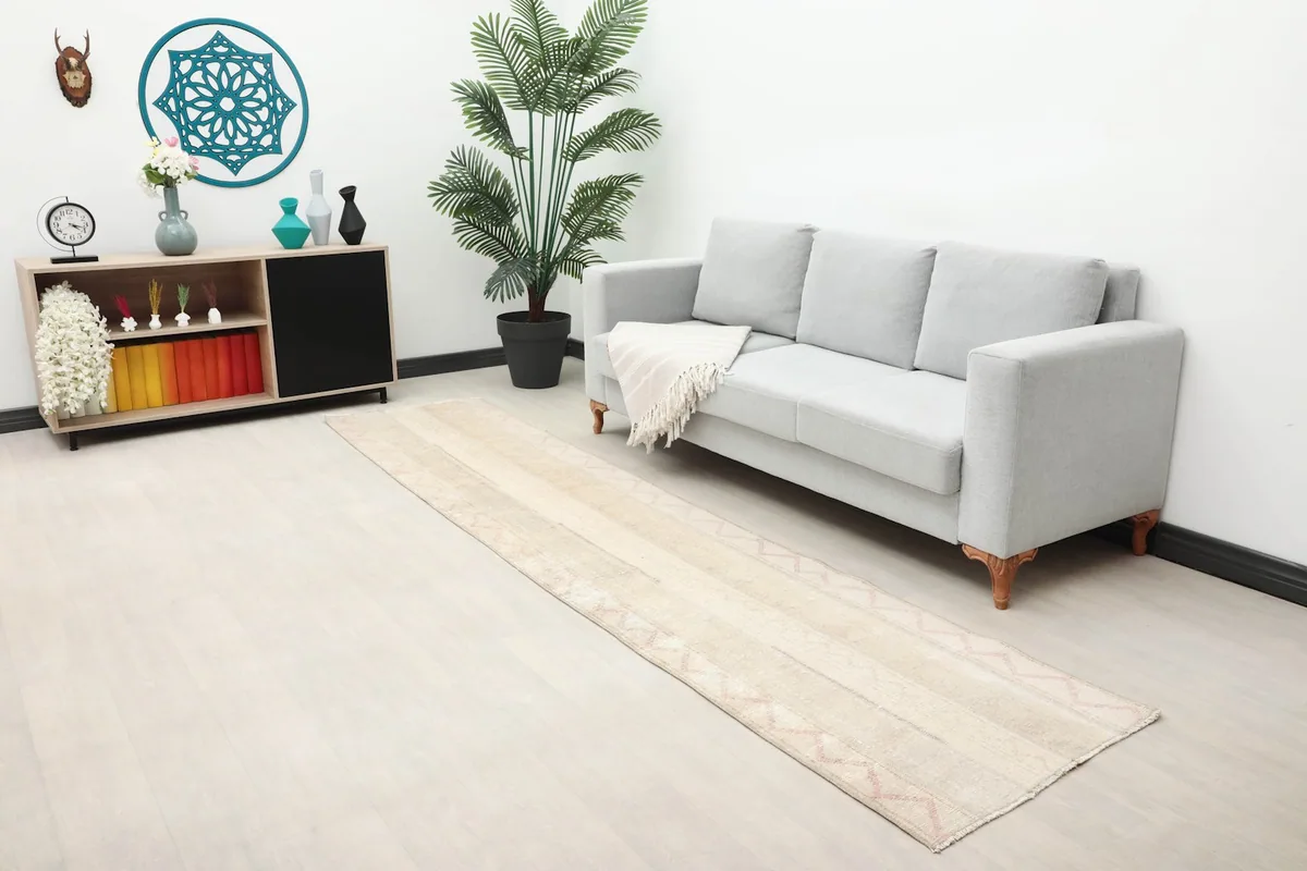Long shot of the ivory and rose runner rug in a modern living space with light-colored walls and furniture