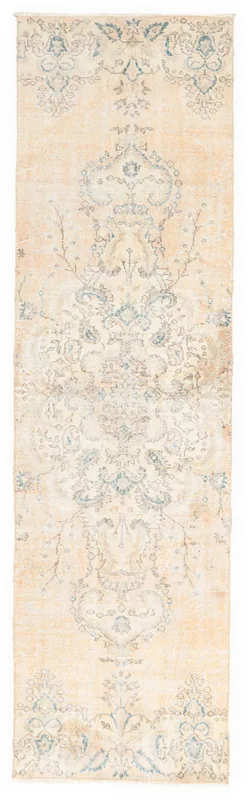 Full overhead view of the beige and blue floral vintage Anatolian runner rug on a white background.