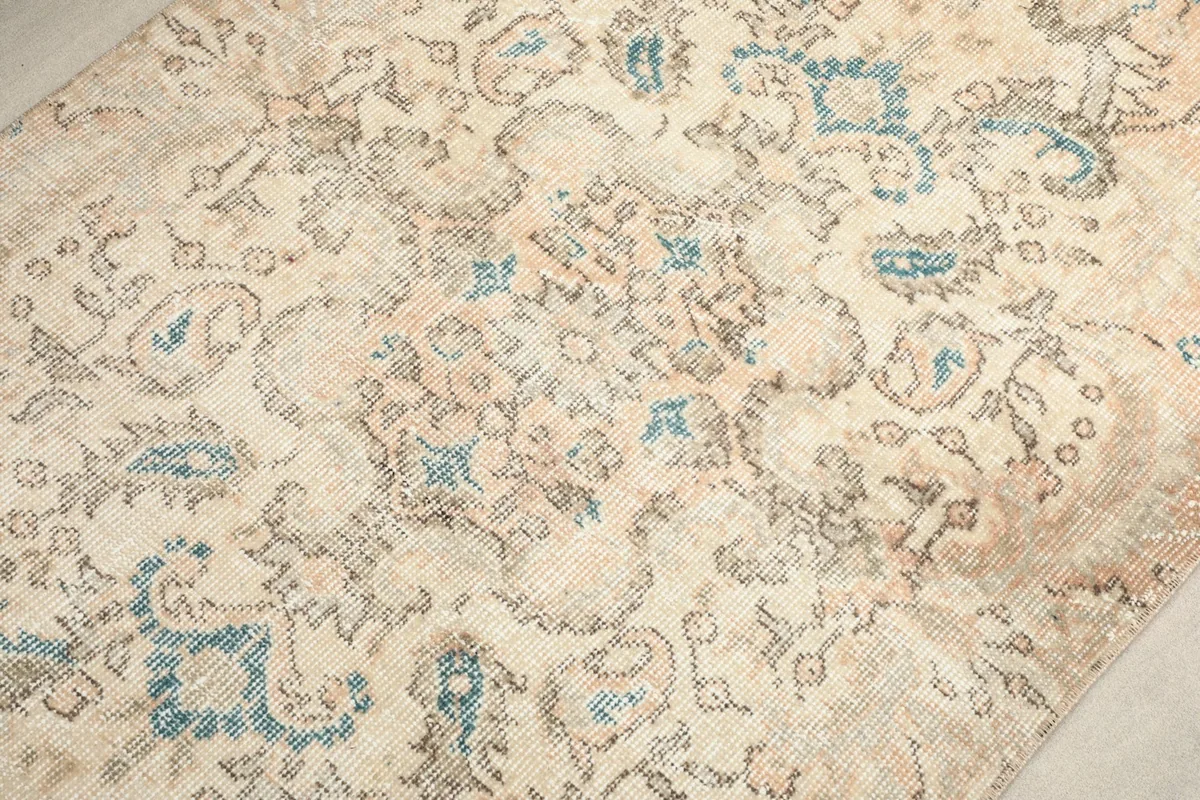 Detailed view of the central design elements and overall texture of the vintage wool pile.
