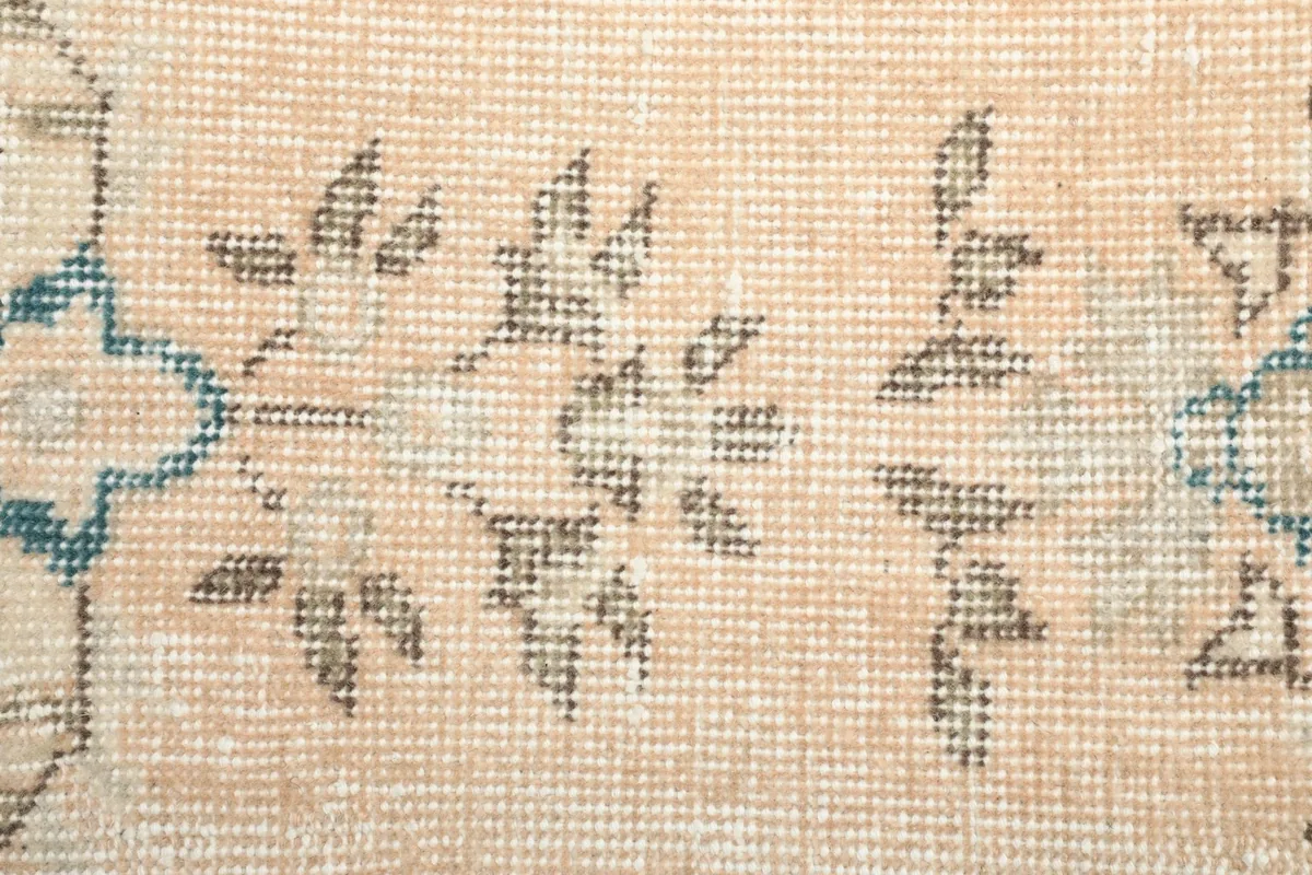 Extreme close-up of the low pile and hand-knotted weave, showing individual fibers and slight wear.