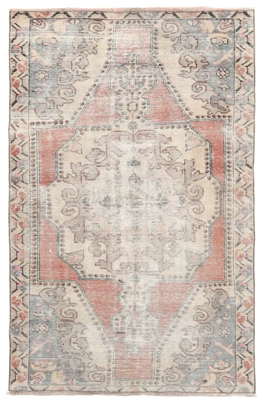 Full overhead view of the vintage Anatolian rug with a rust and beige medallion on a white background
