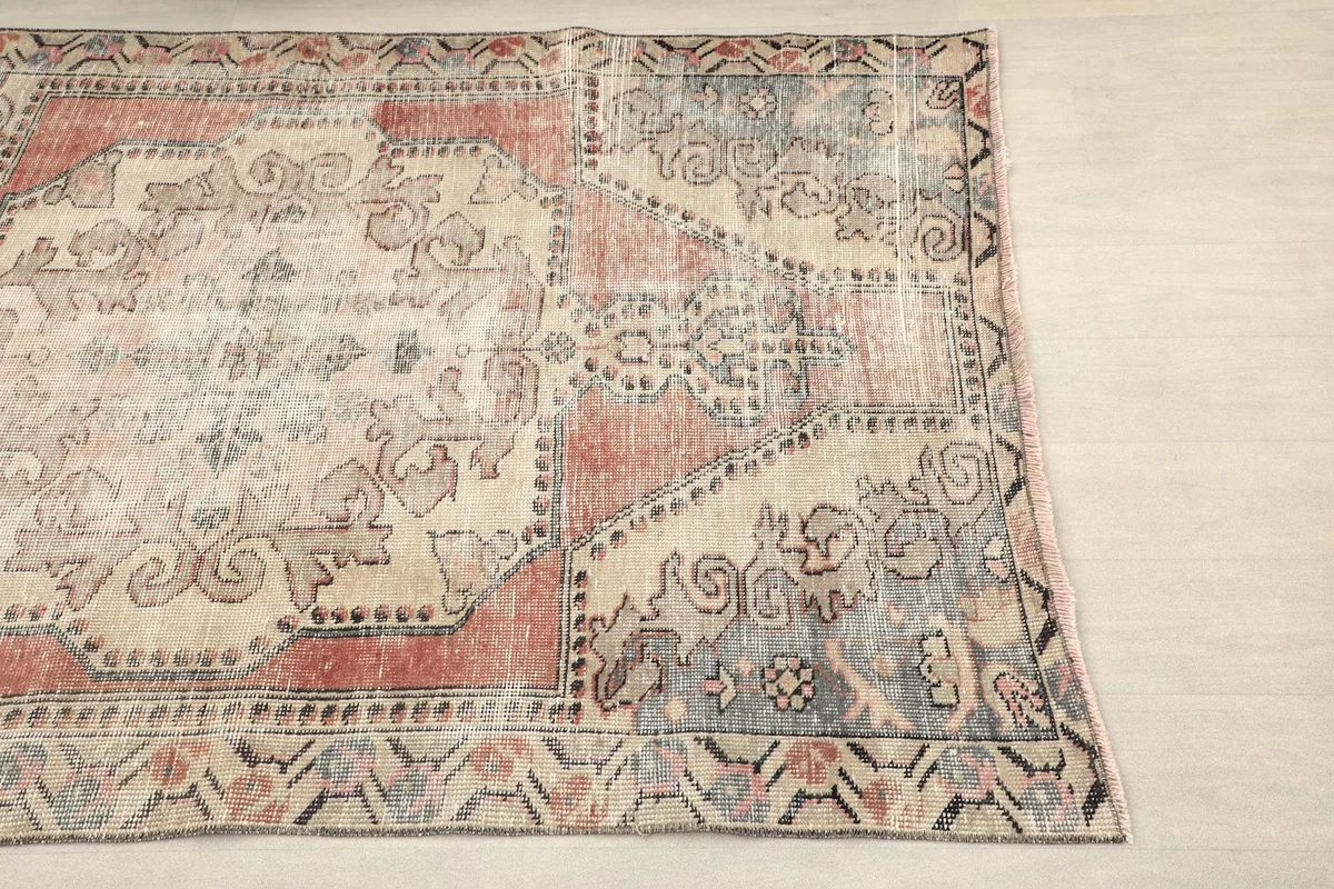 Close-up view of the rug's right side, showing border patterns and faded colors