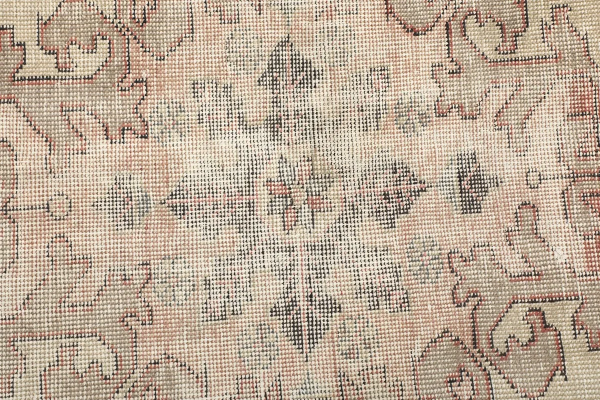 Extreme close-up of the rug's low wool pile, revealing the texture and subtle color variations