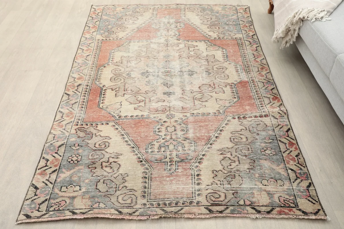 Overhead view of the rug on a light wooden floor, showing its overall design and colors