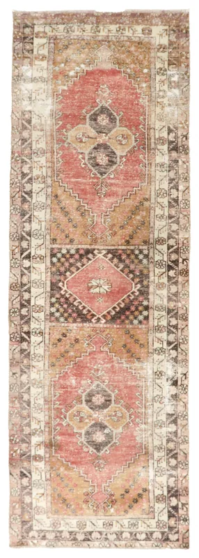 Full top view of the vintage rust tribal medallion runner rug on a white background