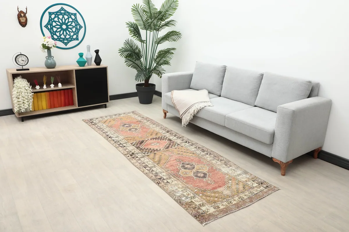 Long view of the hand-knotted rust runner rug placed in a hallway or open living space