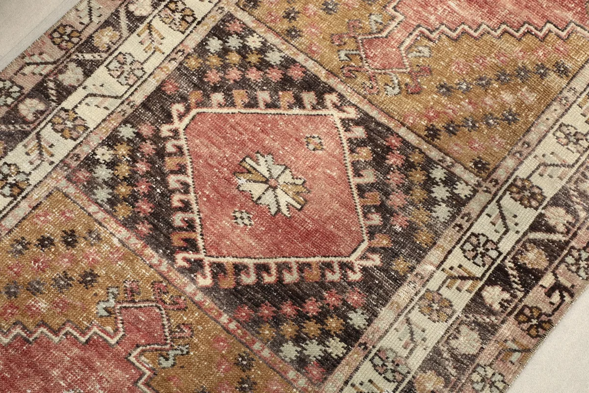 Detailed view of a central geometric medallion and surrounding tribal motifs