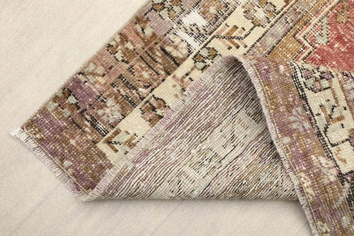 View of the reverse side of the hand-knotted wool rug, showing its foundation