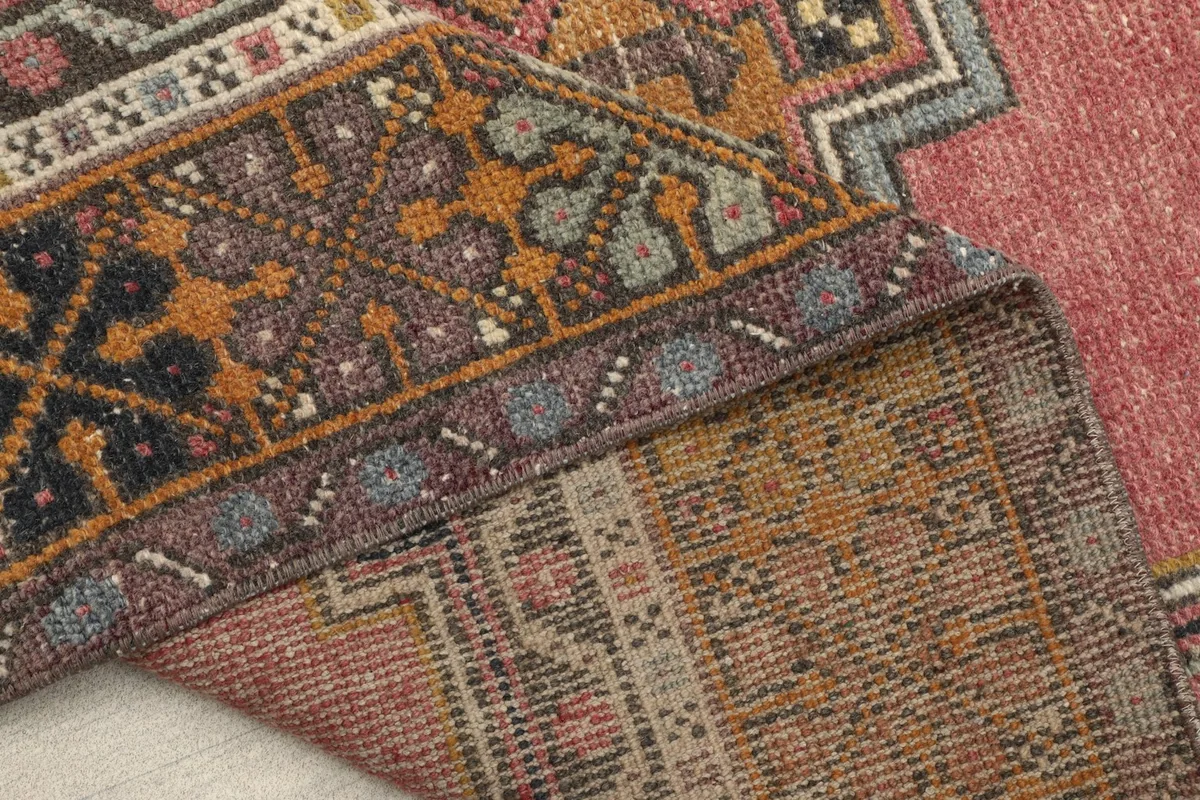 Another folded view showing the back of the rug, highlighting its construction and colors