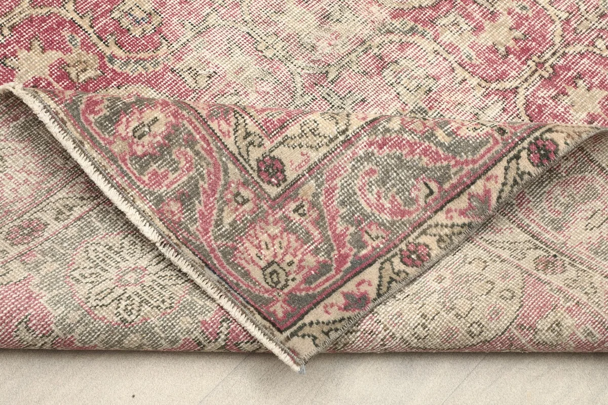 Underside of the rug, revealing the hand-knotted cotton foundation and wool pile