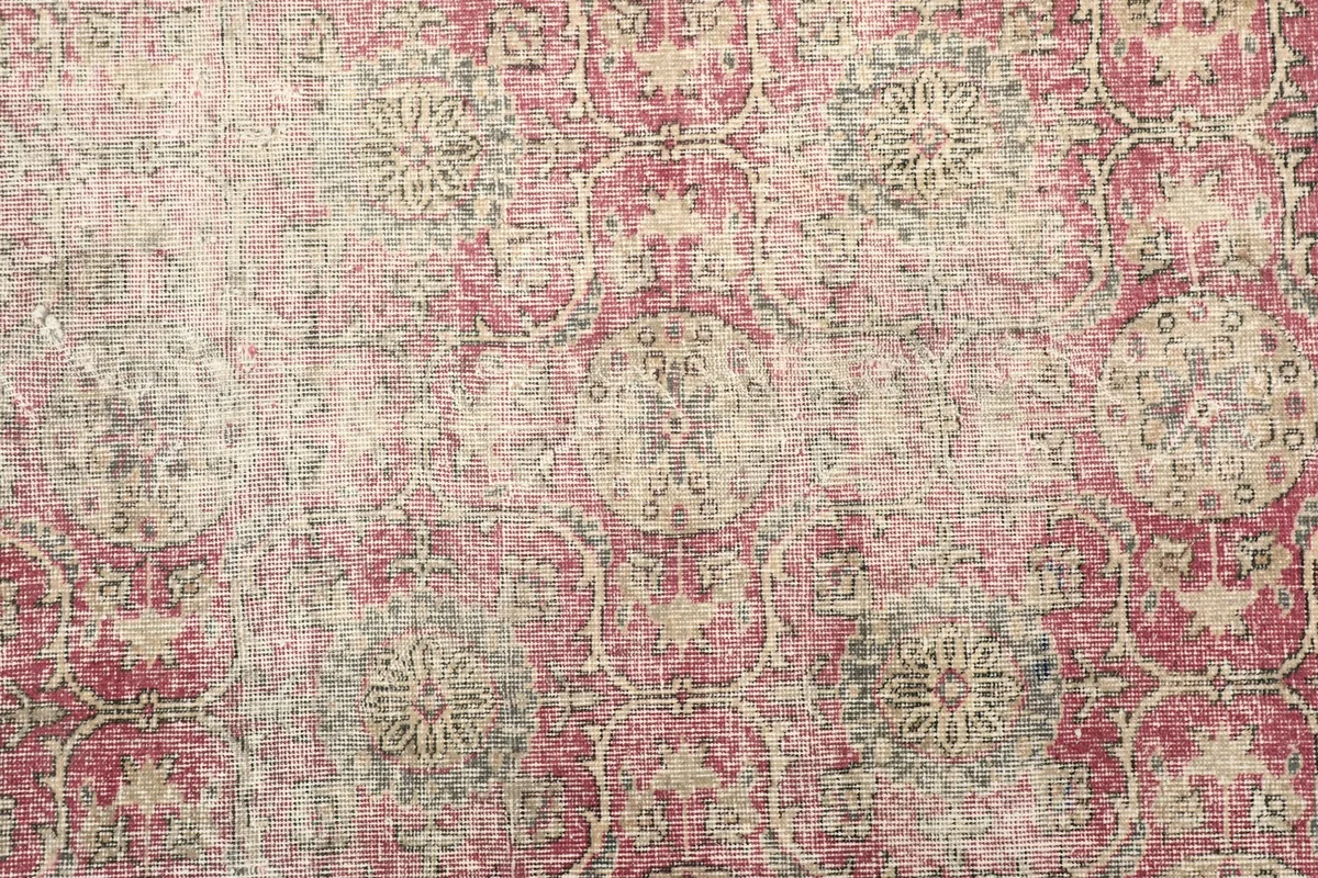 Overhead close-up showing the faded rose field and intricate beige and gray patterns
