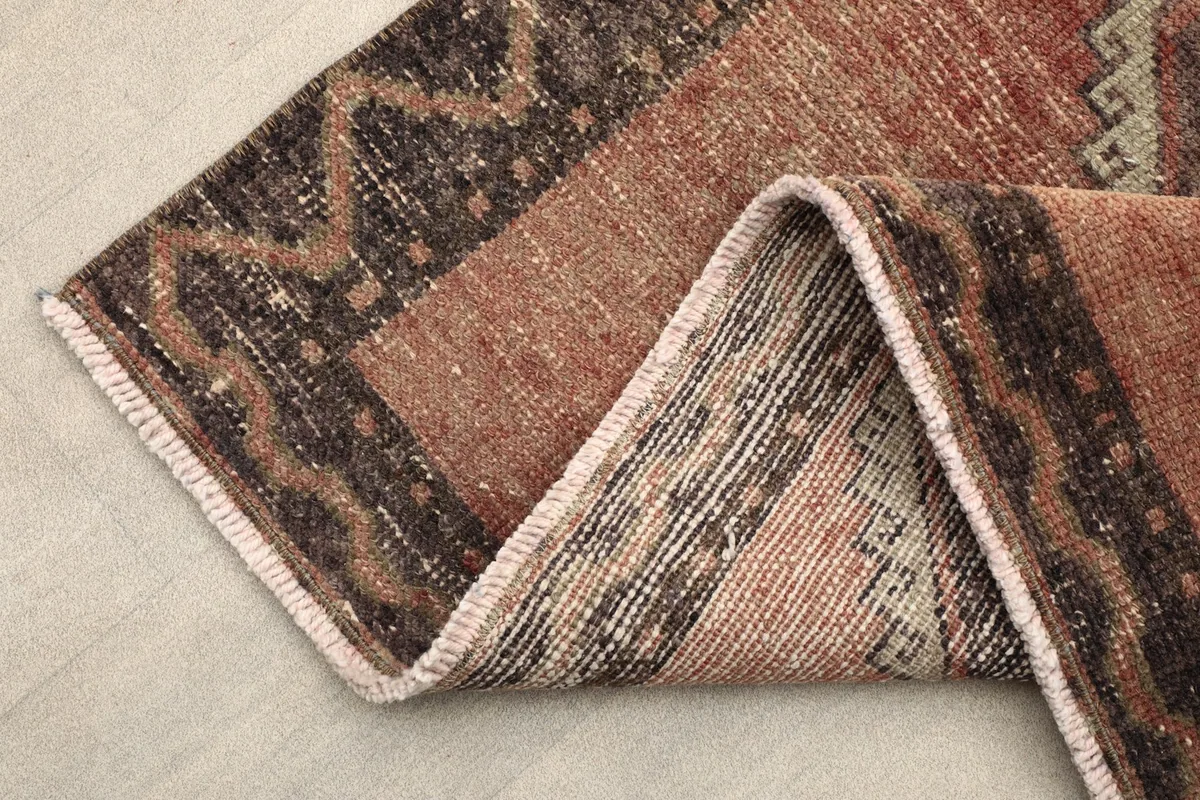 Folded section of the runner, illustrating the thickness and back of the rug