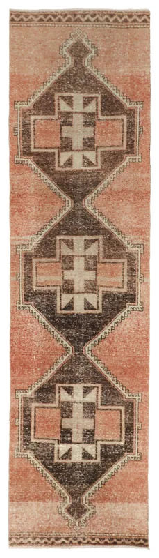 Full overhead view of a 2'11" x 11'7" rust and charcoal geometric Anatolian runner rug on a white background.
