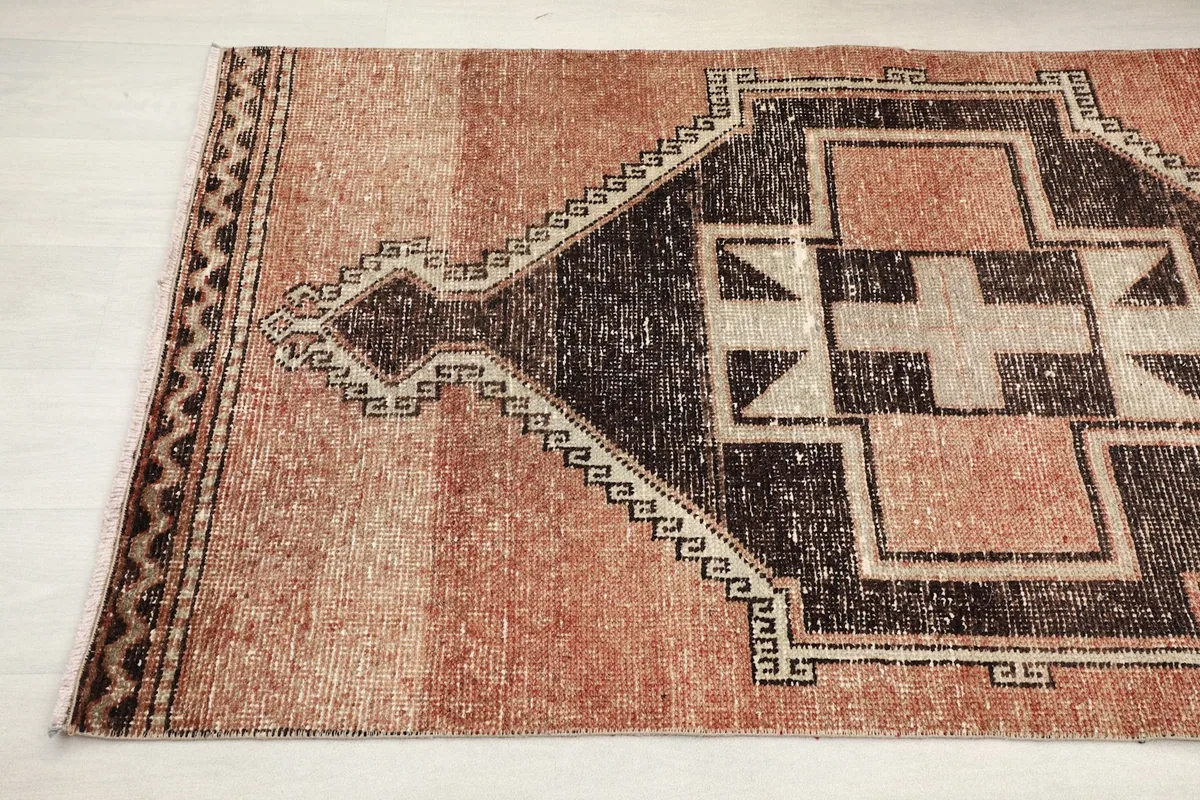 Detail view of the mid-section of the vintage runner, highlighting the distressed rust color and charcoal patterns.