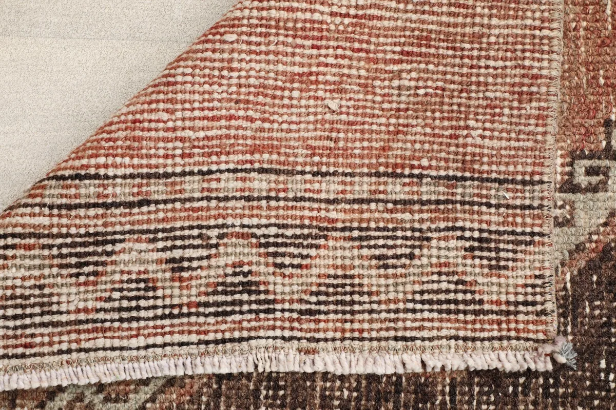 Underside of the vintage wool runner, revealing the cotton foundation and the reverse of the hand-knotted design.