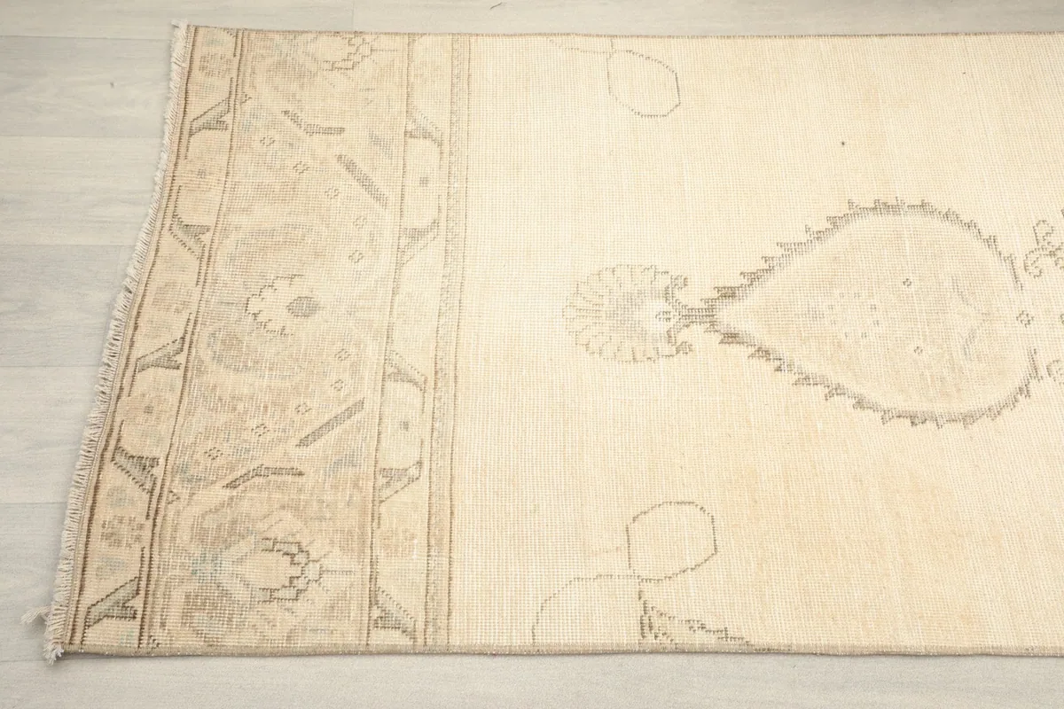 Detail of the rug's side border and field, revealing the subtle color variations and hand-knotted texture