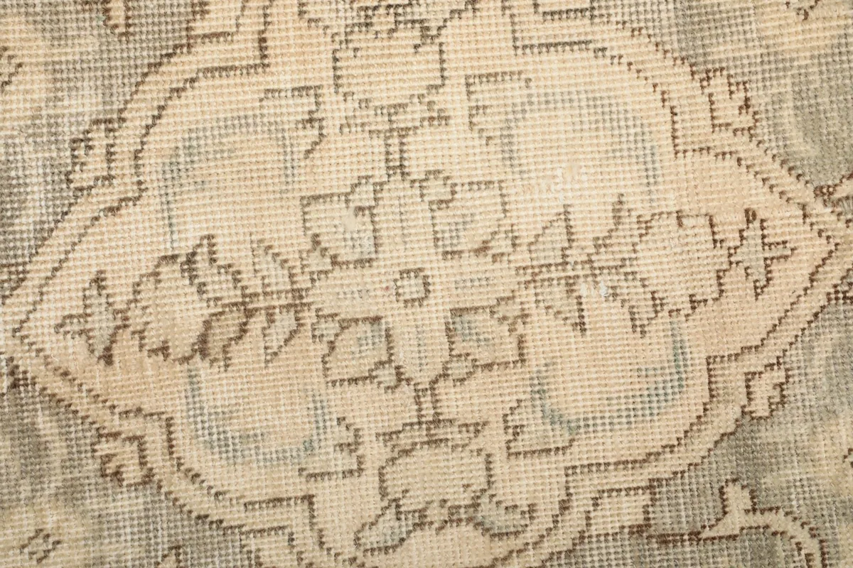 Close-up of the low wool pile and intricate floral patterns within the medallion design