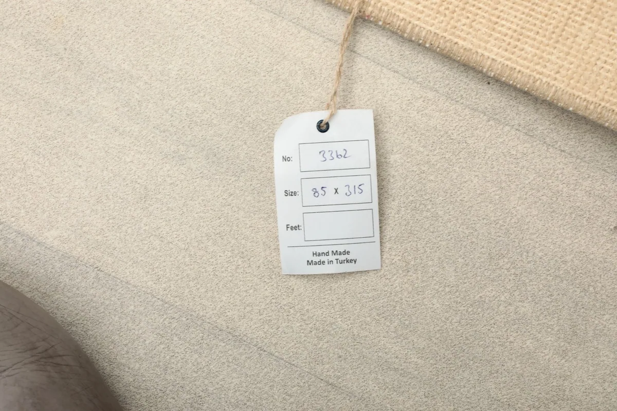 Close-up of the product tag indicating 'Hand Made in Turkey' and the rug's dimensions