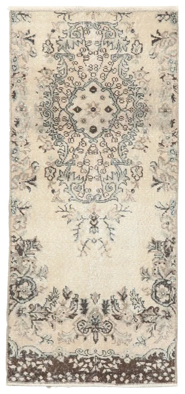 Full top view of the 2'4" x 5'0" ivory vintage Anatolian wool rug with central medallion and botanical motifs