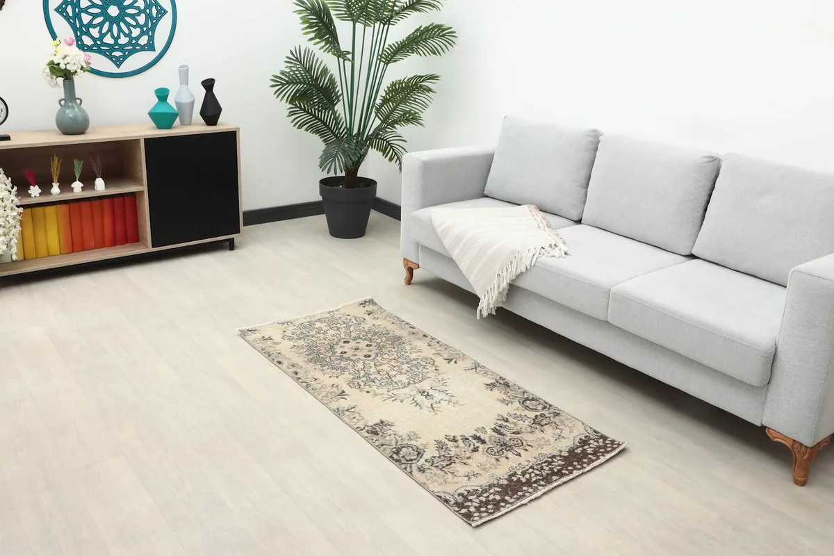 Full room view showing the ivory vintage rug as an accent piece in a modern living space