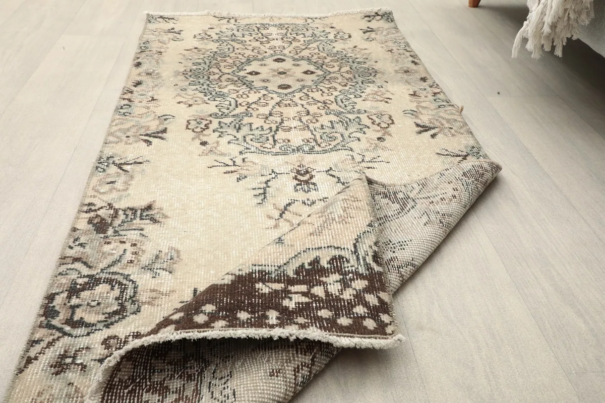 Close-up of the rug's low pile, showing texture and colors in a folded section