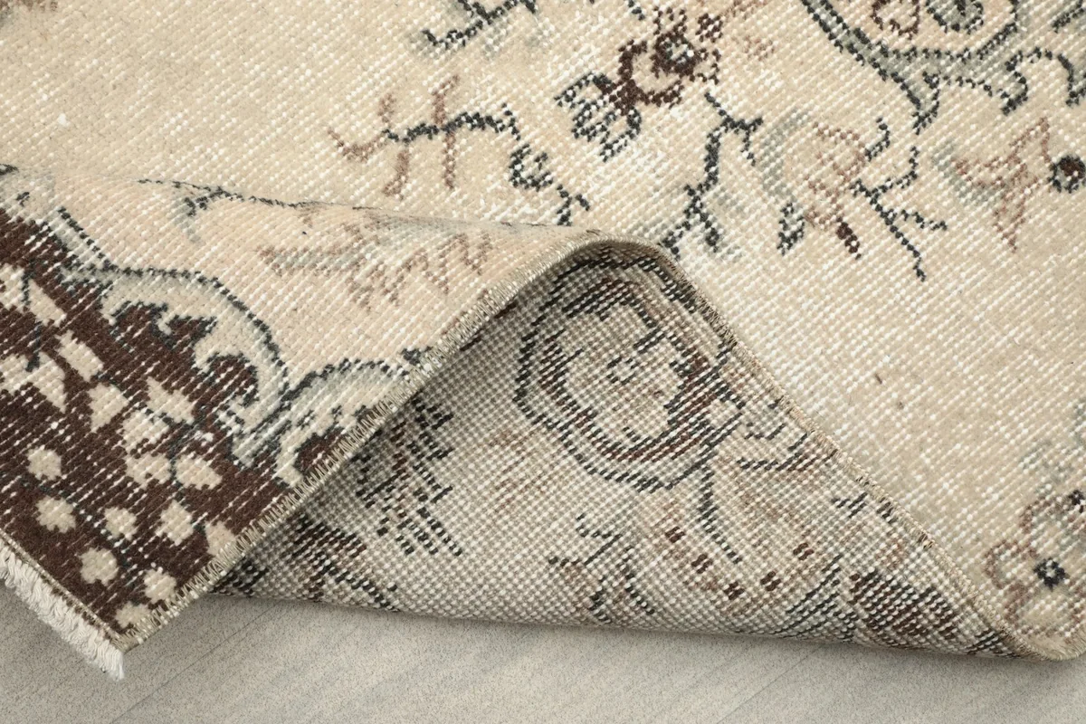 Folded corner of the rug, revealing the reverse side and construction