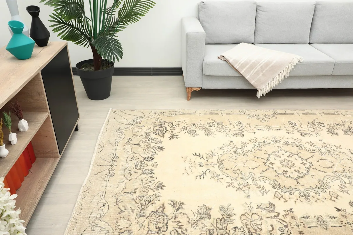 Area rug in a room, offering a perspective of its size and subtle color against light flooring.