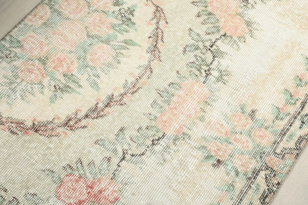 Close-up of the central floral medallion and surrounding patterns on the rug