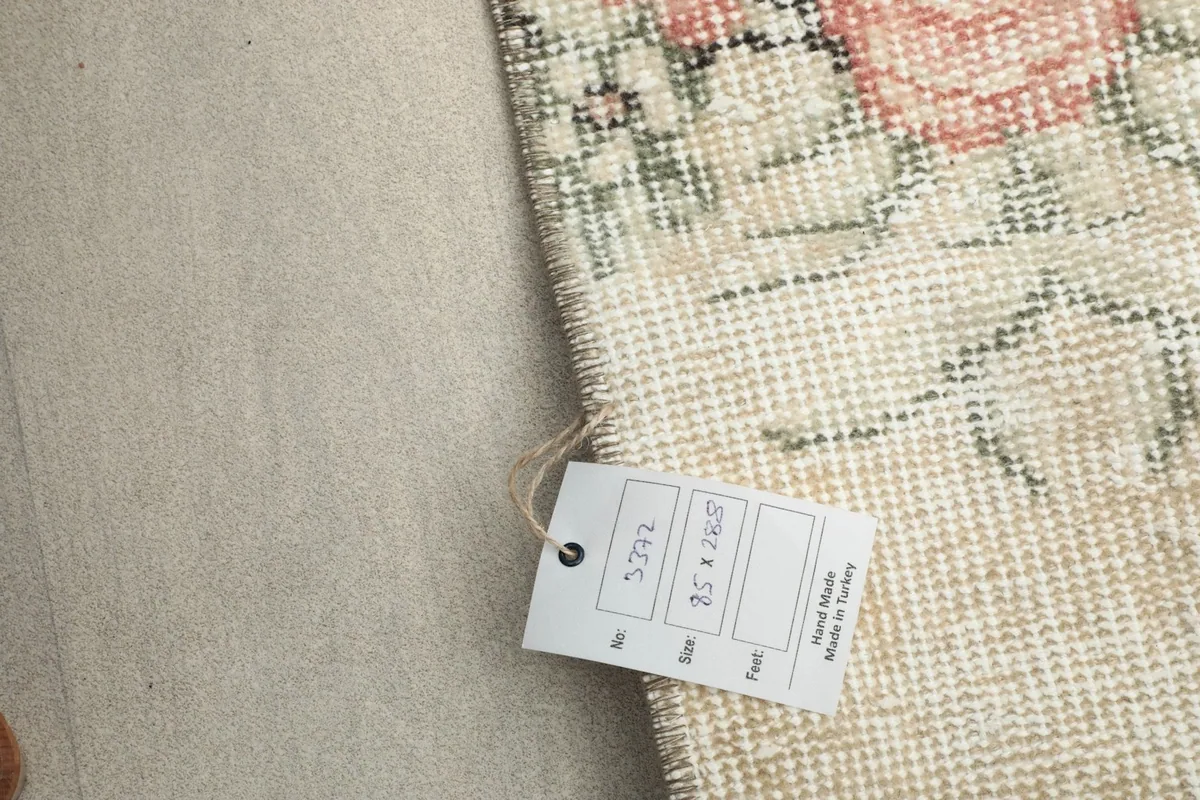 Close-up of the rug's care tag, showing size and origin details