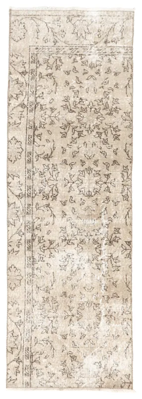 Full top view of the 2'4" x 7'1" tan and brown floral vintage Anatolian runner