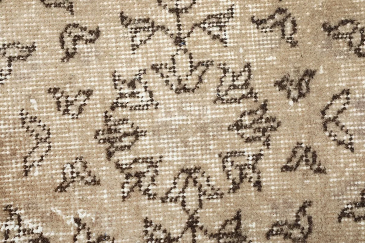 Extreme close-up of a central floral medallion motif, showing individual knots