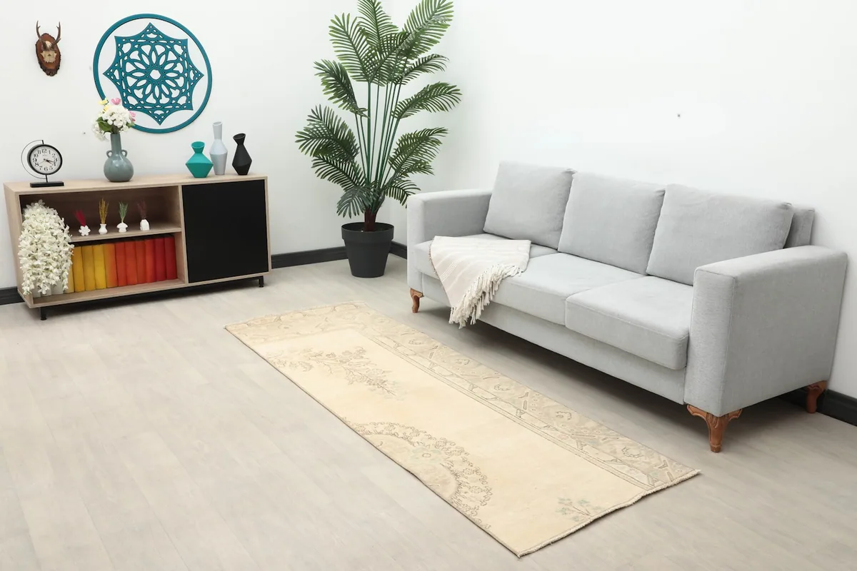 Full view of the runner rug in a living room setting with a sofa and decor.