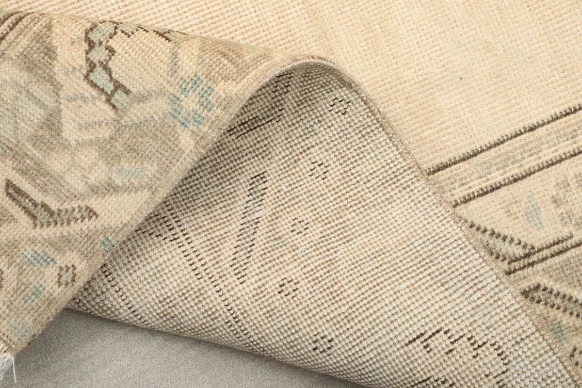 Detailed view of the rug's backside, showing the tight knotting and foundation texture.