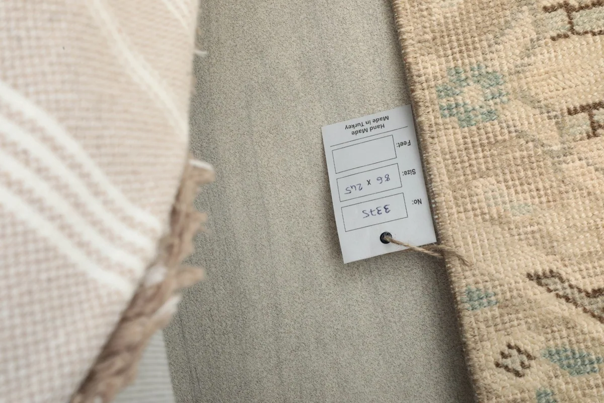 Close-up of the product tag indicating the rug's size and origin.