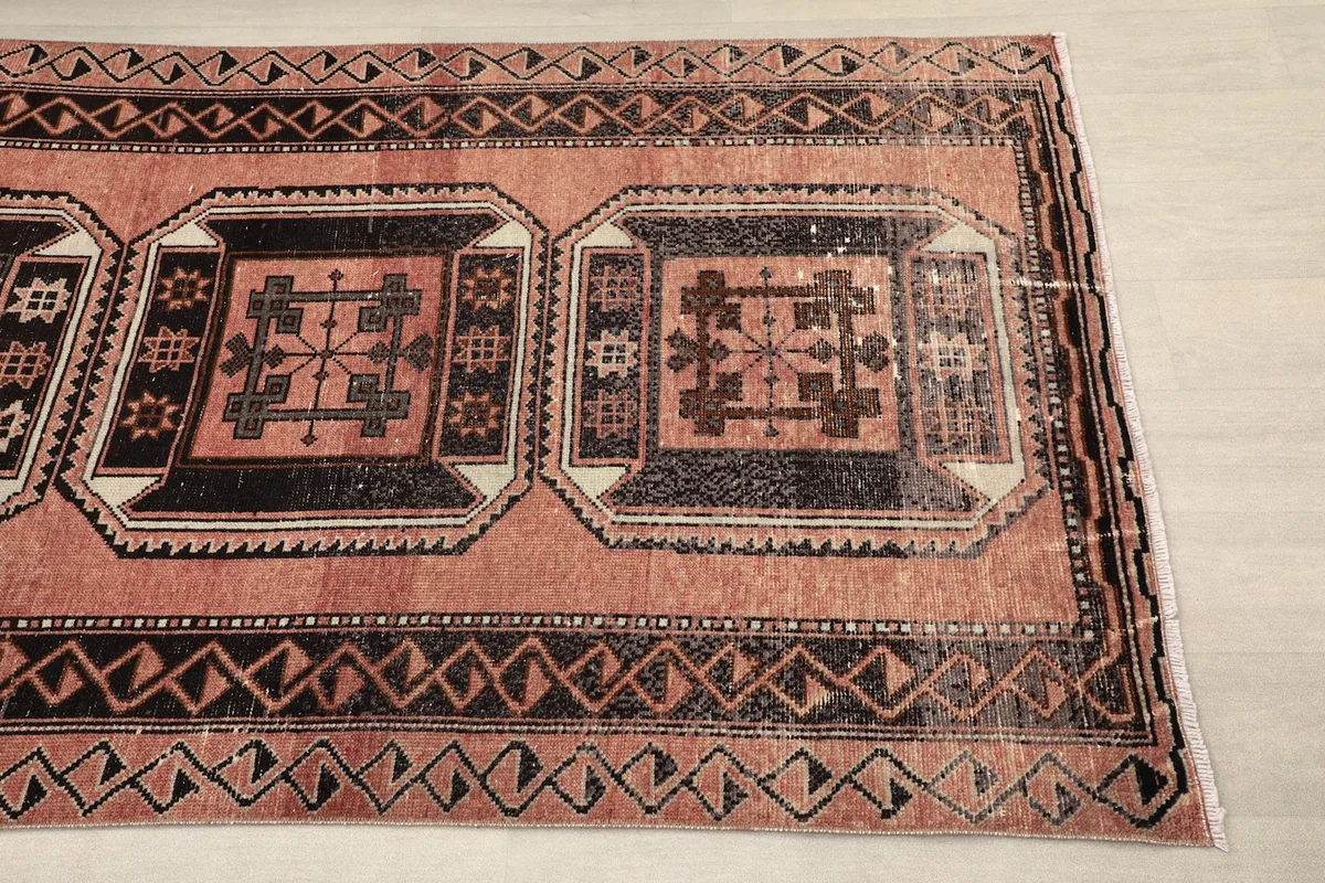 Close-up of the runner rug's central geometric medallions and border patterns.