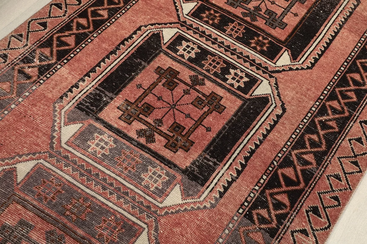 Intricate detail of one geometric medallion with its central design and surrounding patterns.