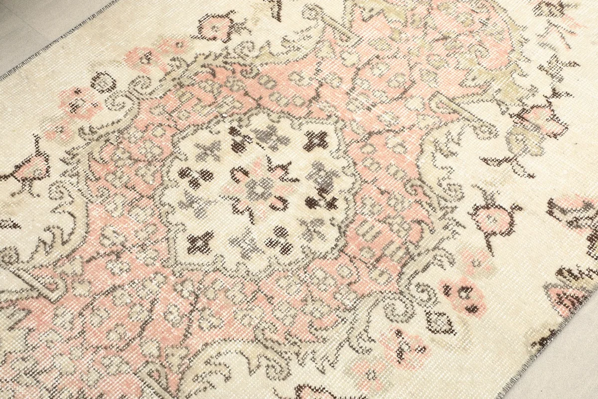 Close-up of the central rose medallion and surrounding floral elements