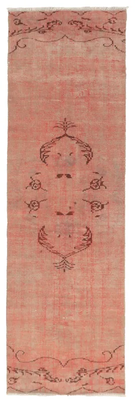 Full overhead view of the 2'6" x 8'0" rose vintage Anatolian runner rug with tribal motifs.
