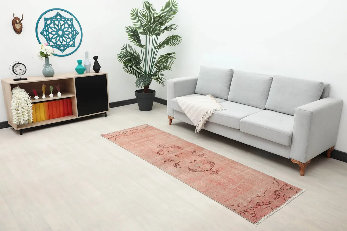 Long shot of the rose runner rug in a modern living space, showing scale with furniture.