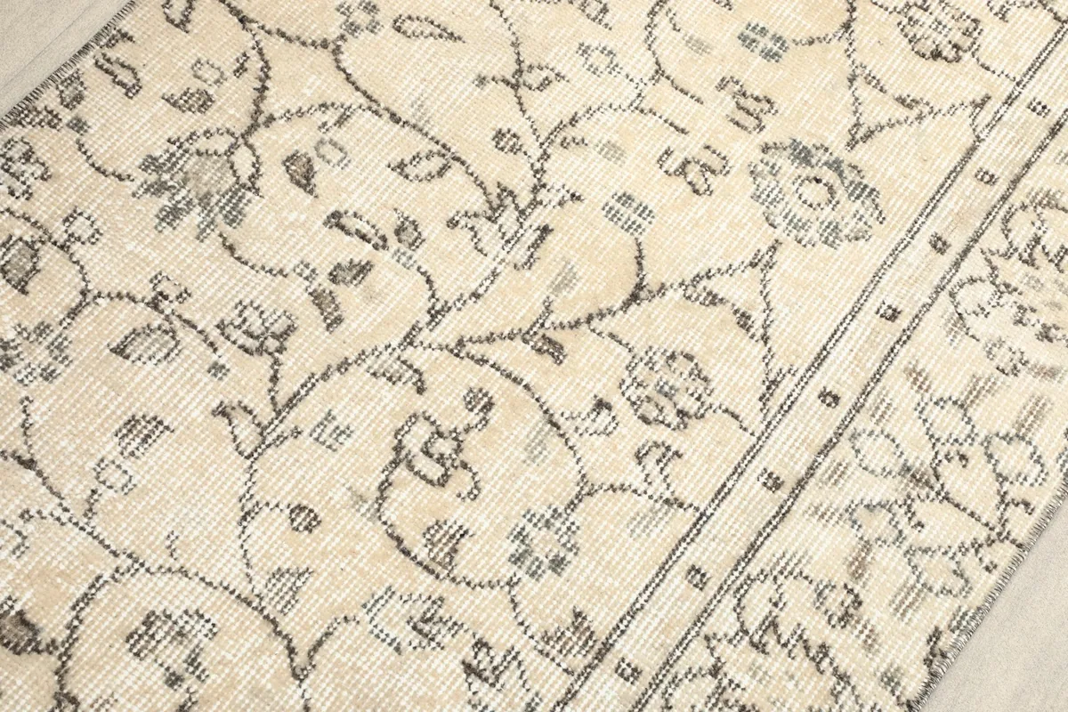 Close-up of the low wool pile, showing the distressed patina and clarity of the charcoal patterns