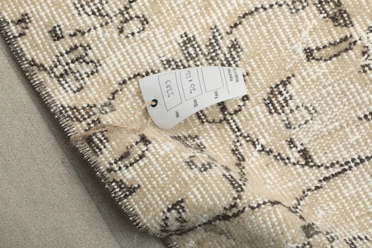 Rug tag detail on the back of the runner, indicating dimensions and material