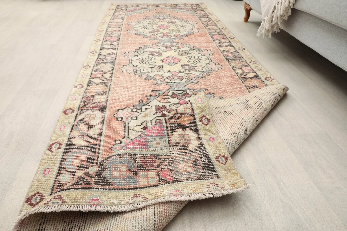 Angled view of the rust runner rug in a room, showing its full length and the texture of the pile.