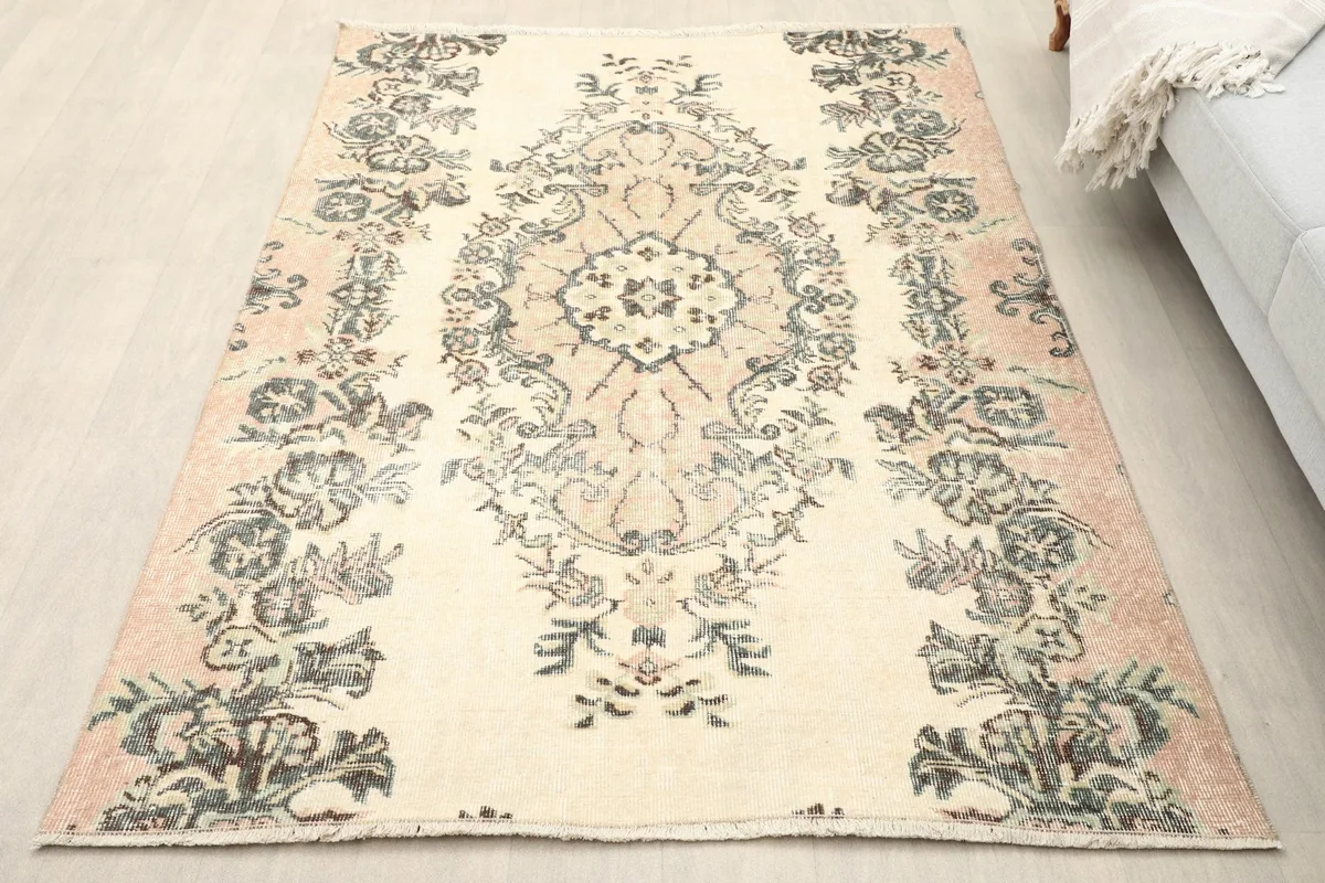 Vintage Anatolian rug on a light floor, showing its placement in a living room setting