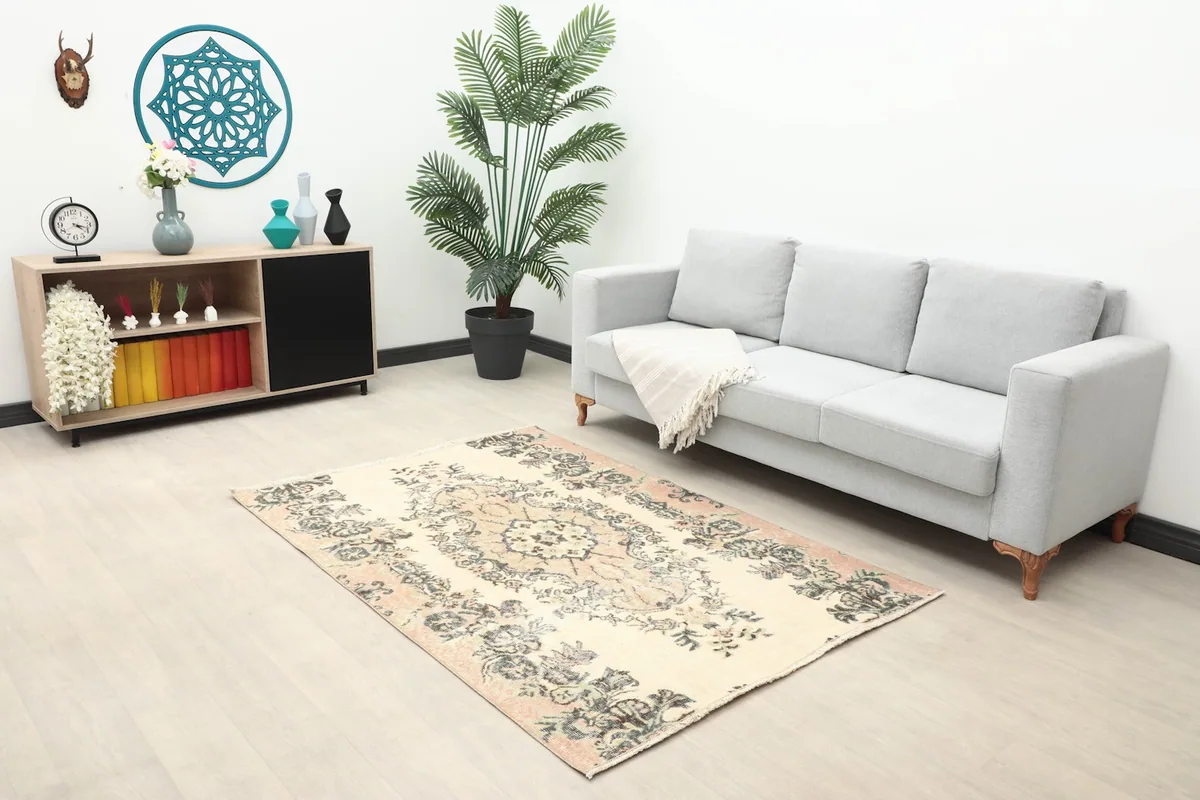 Overhead shot of the small rug in a room, highlighting its size relative to furniture