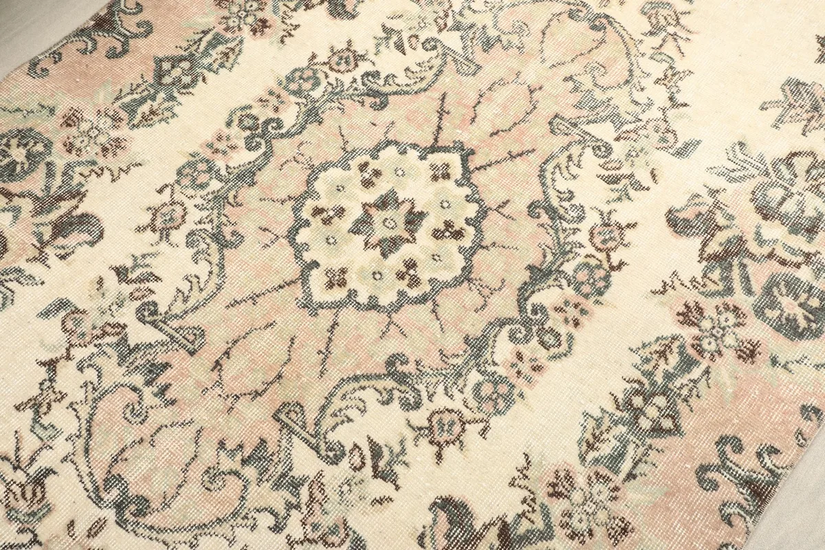 Close-up of the medallion's core design, revealing the hand-knotted texture and colors