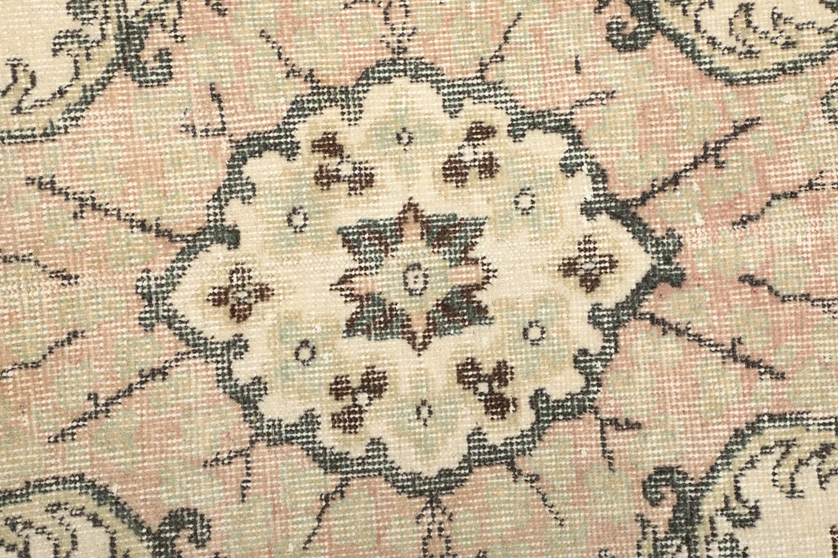 Folded corner of the rug, showing the wool pile and cotton foundation