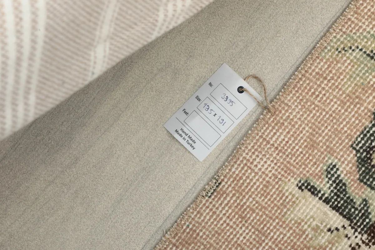 Close-up of the product tag attached to the rug, showing size in cm
