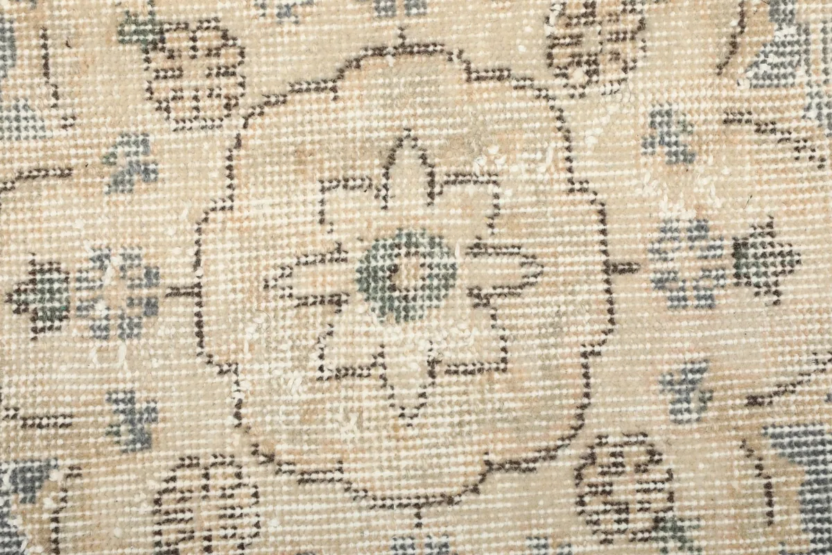 Close-up showing the low wool pile texture and the hand-knotted weave of the vintage rug.